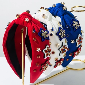 Detail of red white and blue knotted headband with beaded star patches and rhinestones