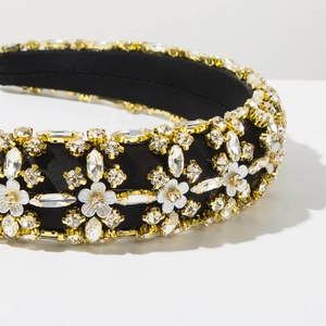 Detail shot of vintage crystal floral padded headband with marquise rhinestones and gold base