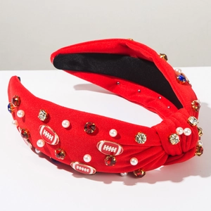 Detail of red knotted headband with white pearls, rhinestones and football charms