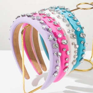 Macro detail of rhinestone heart headbands in purple, pink, white and teal with velvet lining