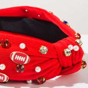 Detailed view of red knotted headband with football charms and pearls for Independence Day