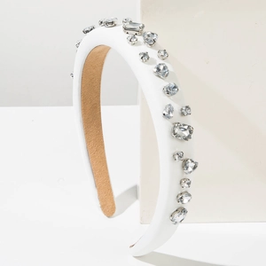 Detail of white padded headband with sparkling irregular crystals and soft non-slip lining