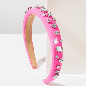 Detail showing fuchsia satin headband decorated with sparkling geometric clear crystals