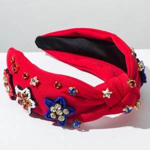 Detail of red fabric headband with handcrafted bead stars and colorful rhinestones