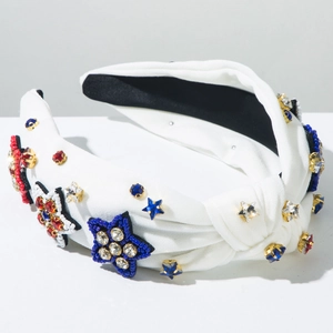 Close-up of white knotted headband with red and blue rhinestone stars and beads