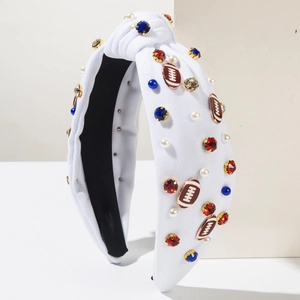 Detail of white knotted headband with blue and red rhinestones, pearls and football charms
