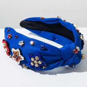 Detail of blue knotted headband with handcrafted beaded stars and colorful rhinestones