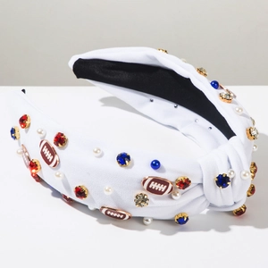 Macro shot of white knotted headband with blue rhinestones and football charms