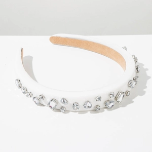 Detailed macro view of white padded headband with sparkling geometric crystals and rhinestones