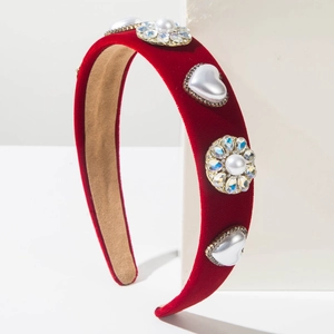 Close-up of red velvet headband with heart pearls, rhinestones and floral details