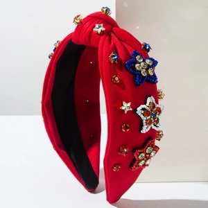 Detail of red knotted headband with beaded star patterns and colorful rhinestones
