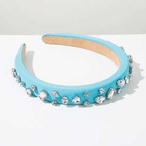 Detail of light blue satin headband featuring sparkling multi-shape rhinestone embellishments