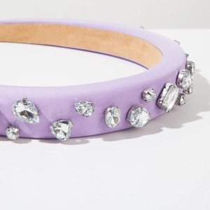 Detail of purple satin padded headband with shimmering multi-shape rhinestone embellishments