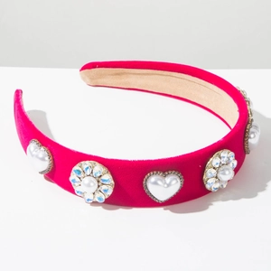 Close-up of rose red velvet headband with pearl hearts and sparkling rhinestones