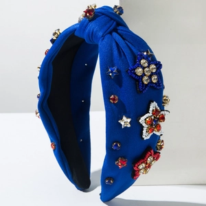 Close-up of blue knotted headband with red and white star sequins and rhinestones