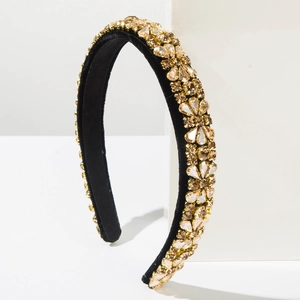 Close-up of vintage Baroque headband with gold crystals on black velvet base