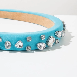 Detailed shot of sky blue satin headband featuring multi-shaped sparkling crystal embellishments
