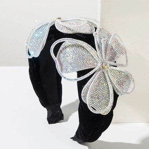 Detail of black velvet headband with three sparkling rhinestone butterfly ornaments