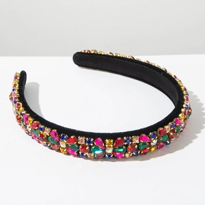 Detail of luxury baroque headband with colorful rhinestones and gold claw settings