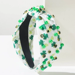 Close-up of Saint Patrick's Day headband with green shamrocks, pearls and crystals