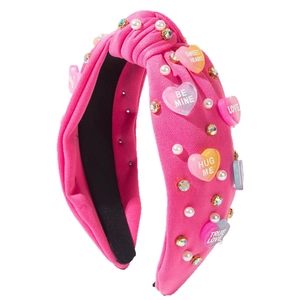 Pink knotted headband with colorful rhinestones, pearls and sweet heart acrylic patterns