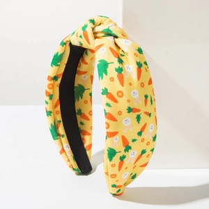 Detail of yellow fabric headband with bunny and carrot print and top knot detail