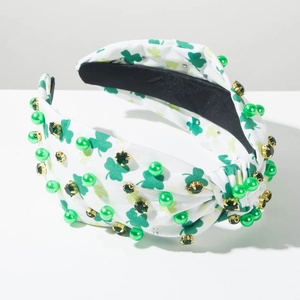 Detail of St. Patrick's Day headband with green pearls, clover print and gold-set gems