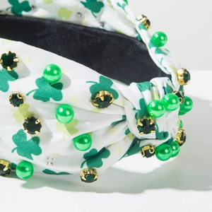 Detail of St. Patrick's Day headband with green shamrock prints, pearls and crystals