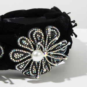 Détail macro du serre-tête baroque avec strass arc-en-ciel et grande perle blanche