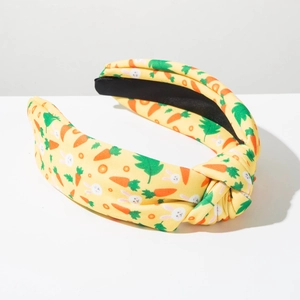 Detail of yellow fabric top knot headband with Easter rabbit and carrot patterns