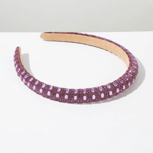 Detail of purple padded headband featuring rhinestones and soft suede lining