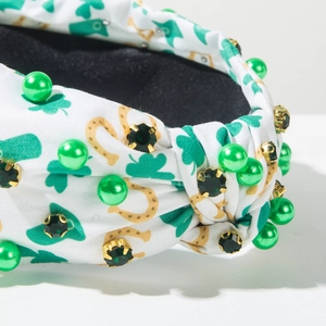 Detail of St. Patrick's Day headband with green shamrock prints, pearls and rhinestones