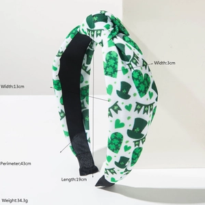 Wide knotted St. Patrick's Day headband with green heart and hat patterns on white fabric
