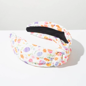 Detail of fabric headband with Easter egg prints and knotted bow texture close-up