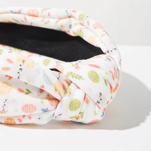 Detail of fabric headband with Easter egg and bunny print featuring a top knot design