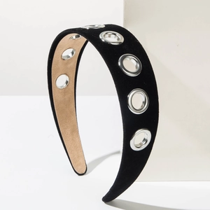Baroque style wide black velvet headband with silver metal grommets on a display pedestal