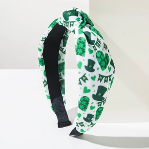 Detail of St. Patrick's Day headband with shamrock hearts and green Irish hat patterns