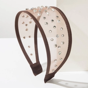 Brown mesh wide headband with glittering rhinestones and silver rivets on white display