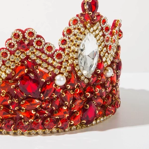 Detail of baroque bridal crown with red rhinestones, pearls and a large marquise diamond