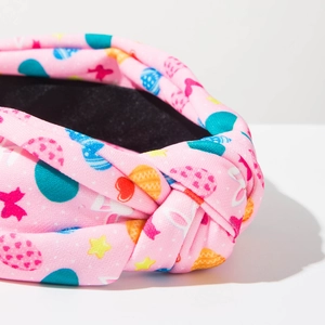 Detailed close-up of pink Easter fabric headband featuring bunny and egg prints with top knot