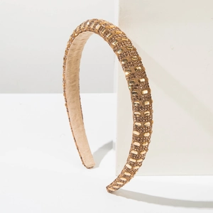 Detailed macro of crystal embellished headband with non-slip inner suede lining