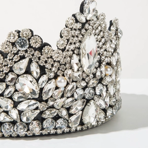 Macro shot of sparkling rhinestones and pearls on a luxurious baroque crown headband