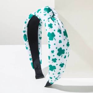 St. Patrick's Day wide knotted headband with green shamrock patterns on white fabric
