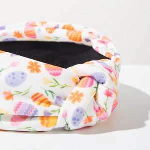 Detail of Easter knotted headband featuring colorful hand-painted eggs and floral patterns