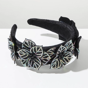 Macro shot of 3D flowers with iridescent rhinestones on a vintage baroque headband