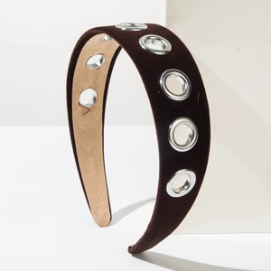 Detail view of brown velvet headband featuring silver metal grommets and non-slip lining