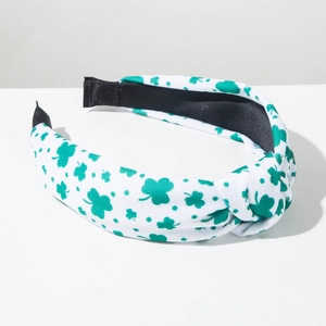 Detail view of St. Patrick's Day wide knotted headband with green shamrock pattern