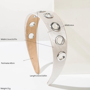 Vintage cream headband with metal eyelets and textured wide band on minimalist background