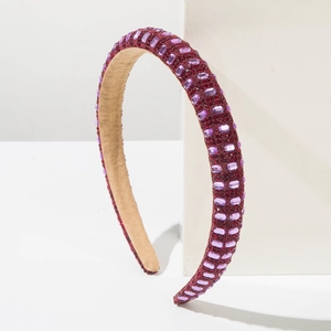 Elegant purple crystal padded headband with sparkling beads on minimalist white stand