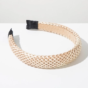 Detail view of champagne handmade woven headband with textured raffia braids and soft lining